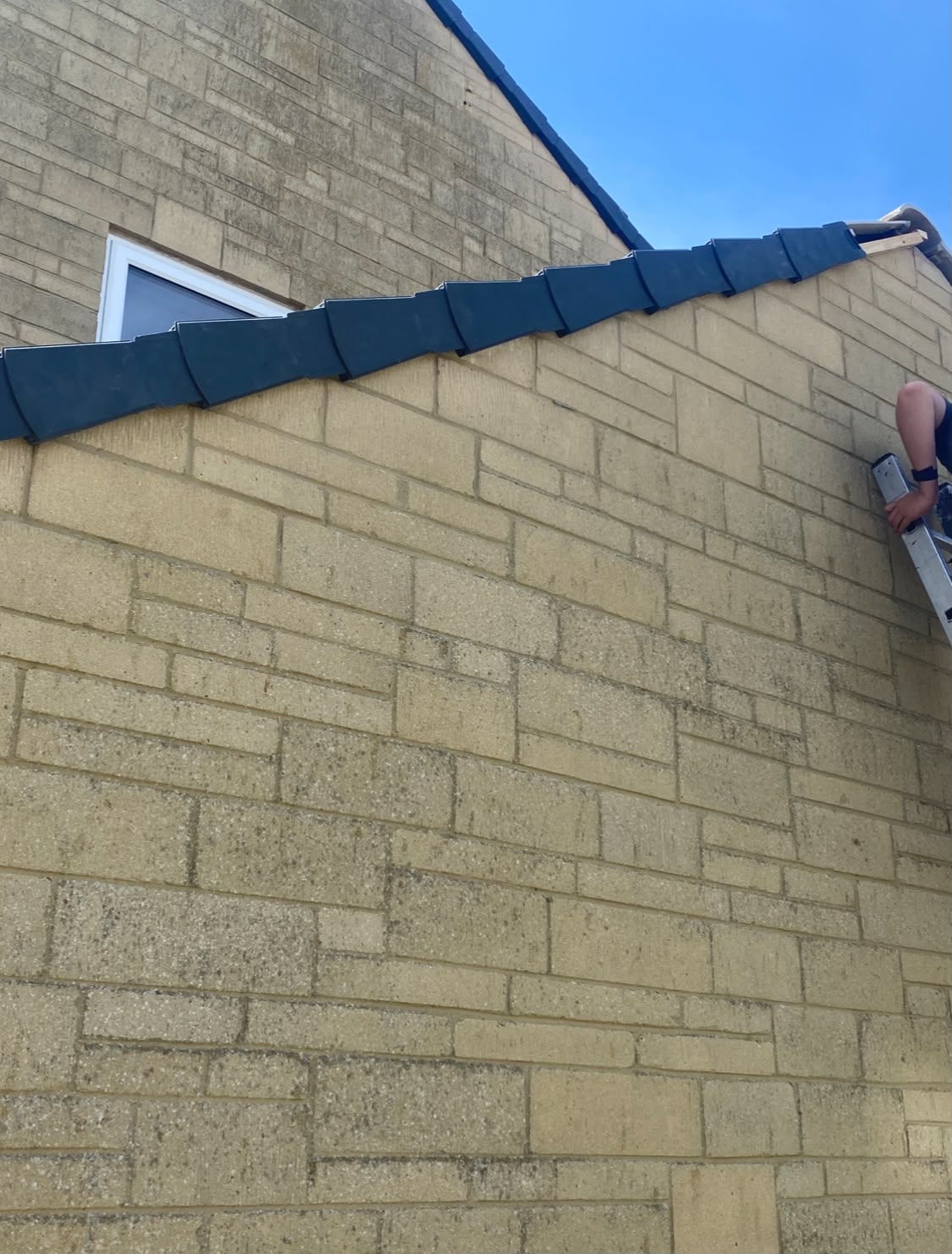 Dry ridge tiles secured along a roof peak